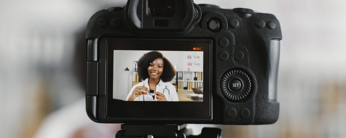 Person recording short-form video content with a camera for social media marketing campaign.