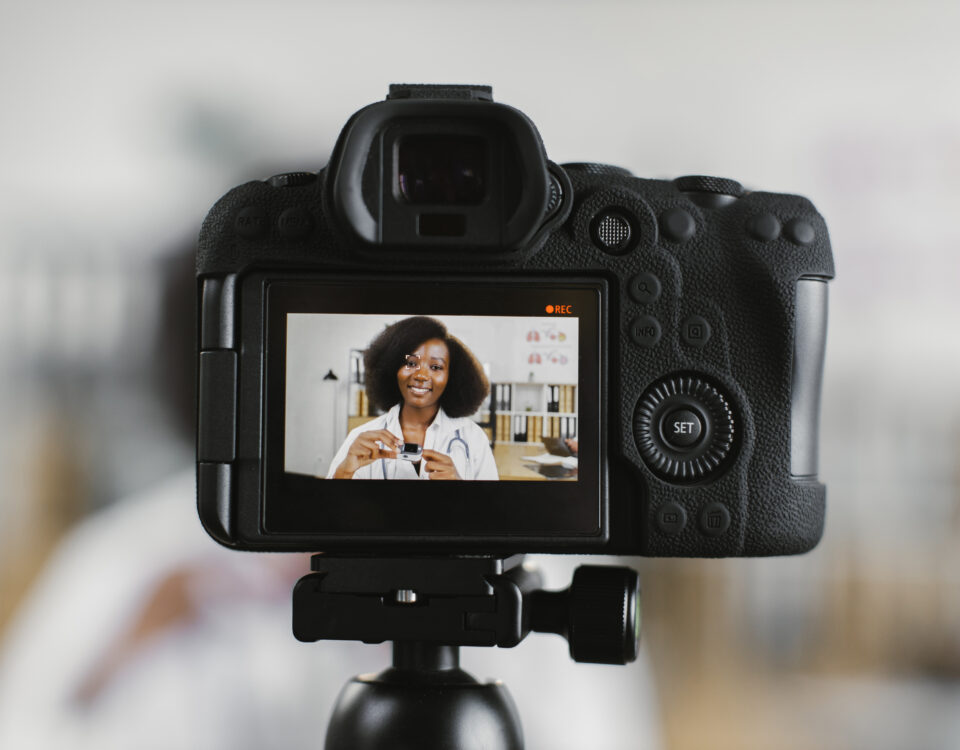 Person recording short-form video content with a camera for social media marketing campaign.