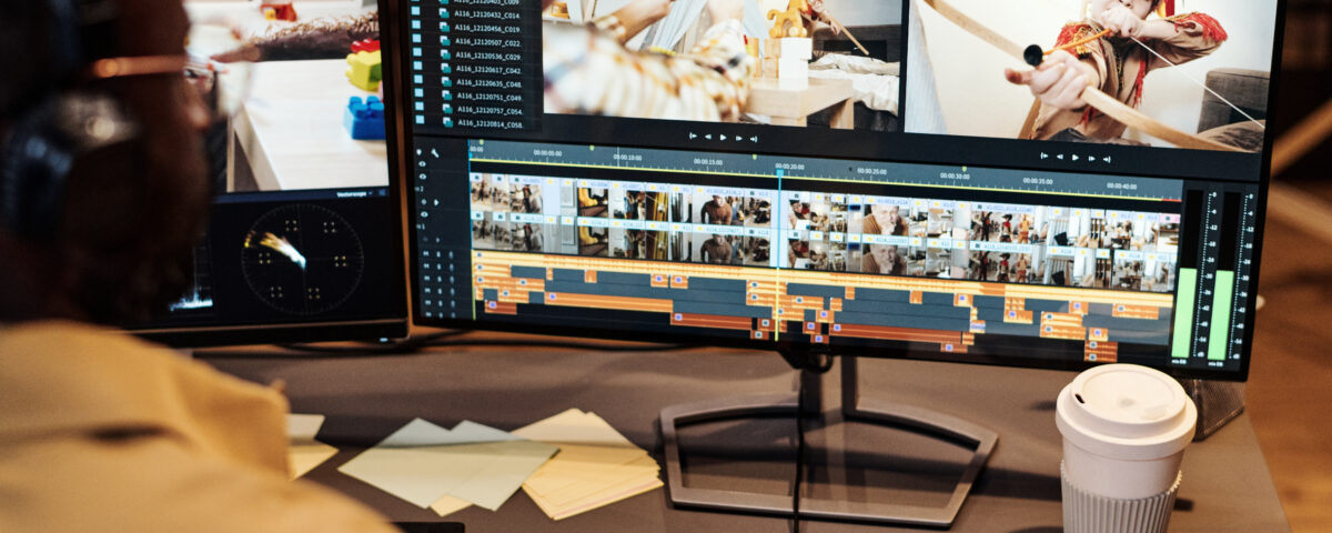 A Long Island video marketing specialist editing a professional video on dual monitors, representing Idea Stream Marketing’s AI-powered videography services.