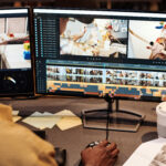 A Long Island video marketing specialist editing a professional video on dual monitors, representing Idea Stream Marketing’s AI-powered videography services.