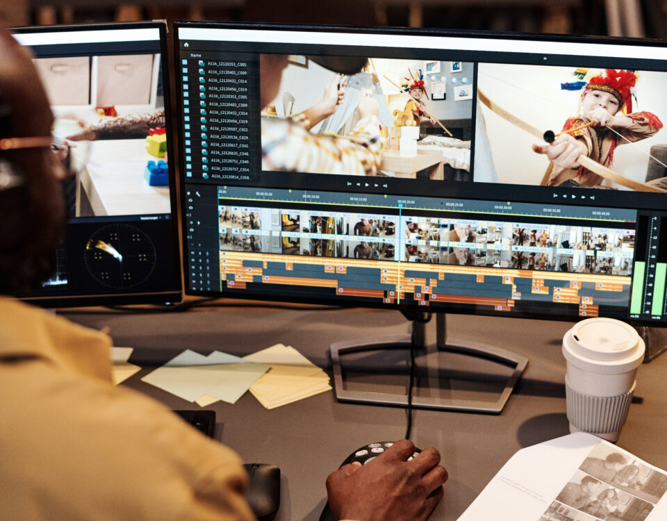 A Long Island video marketing specialist editing a professional video on dual monitors, representing Idea Stream Marketing’s AI-powered videography services.