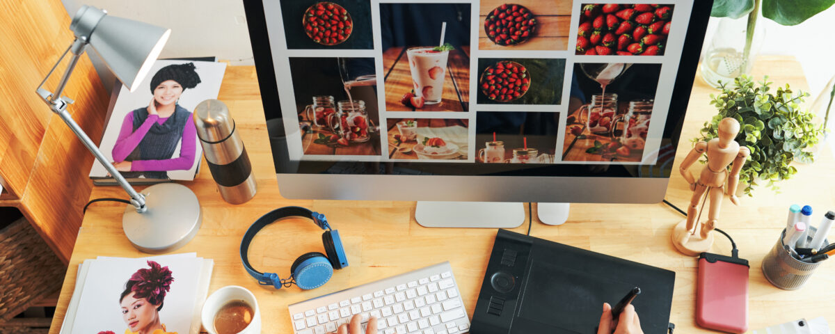 Designer working on modern website layout showcasing digital images and creative branding on desktop computer