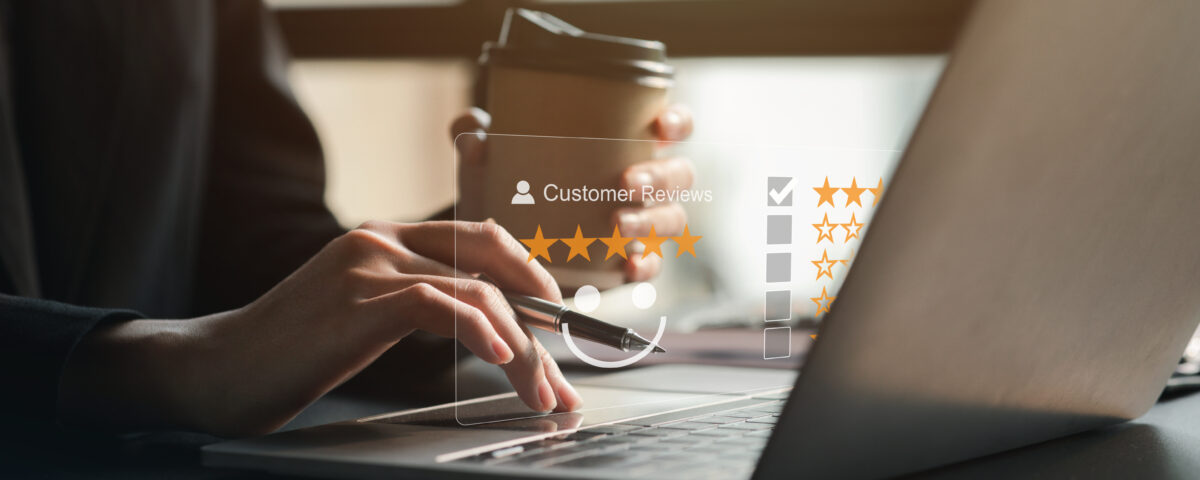 Laptop displaying a Google review with five stars for a local business