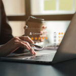 Laptop displaying a Google review with five stars for a local business