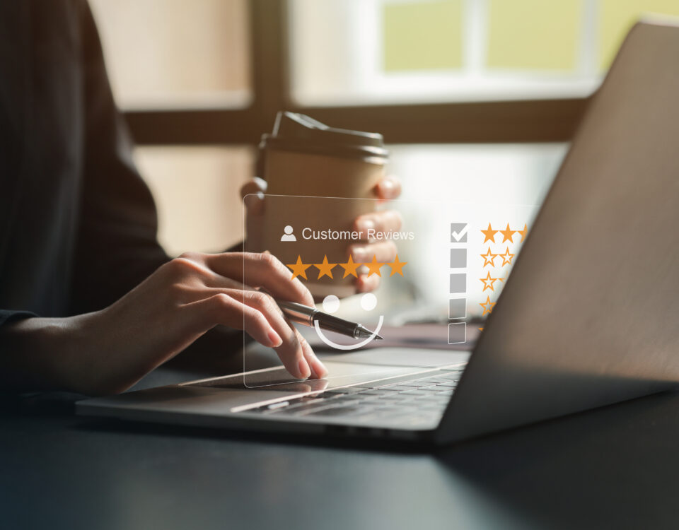 Laptop displaying a Google review with five stars for a local business