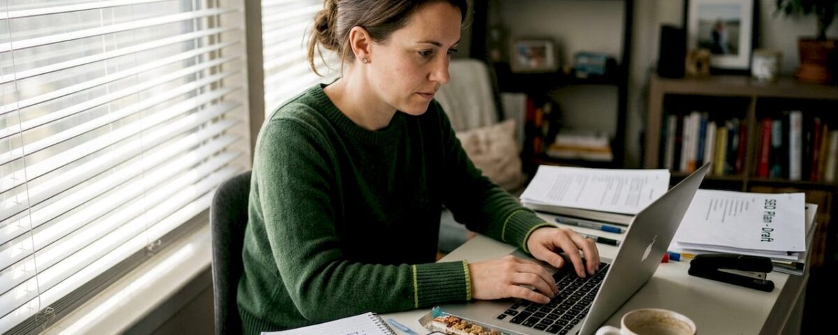 Woman works on digital marketing at home desk