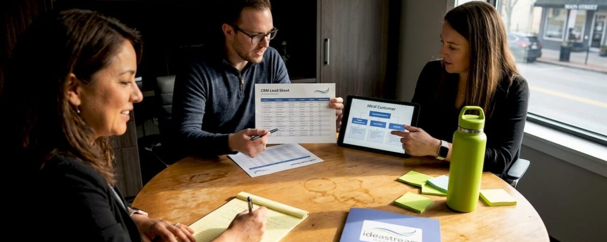 Small business team reviews lead generation strategy