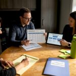 Small business team reviews lead generation strategy