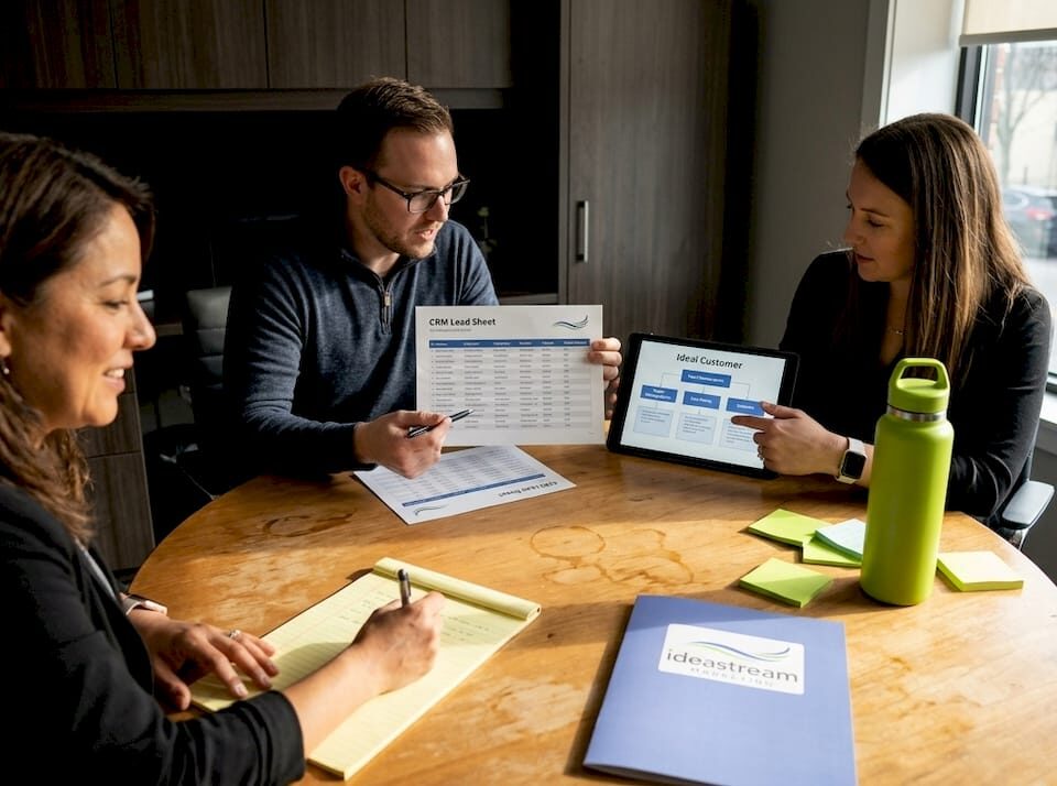 Small business team reviews lead generation strategy