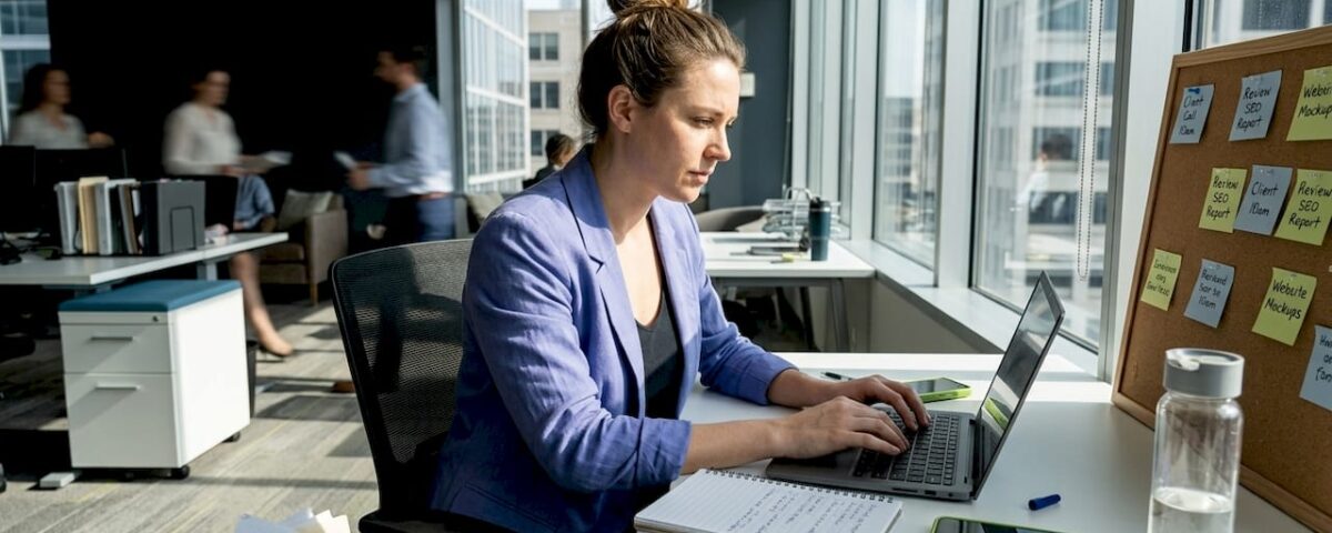 Marketer working at window-side office desk