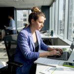 Marketer working at window-side office desk