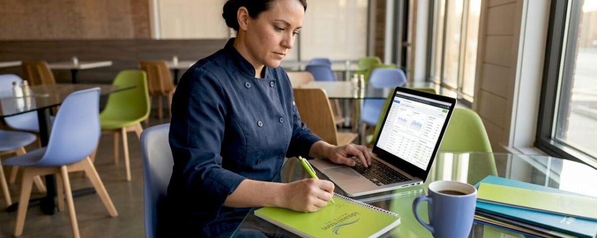 Restaurant owner analyzes marketing at table