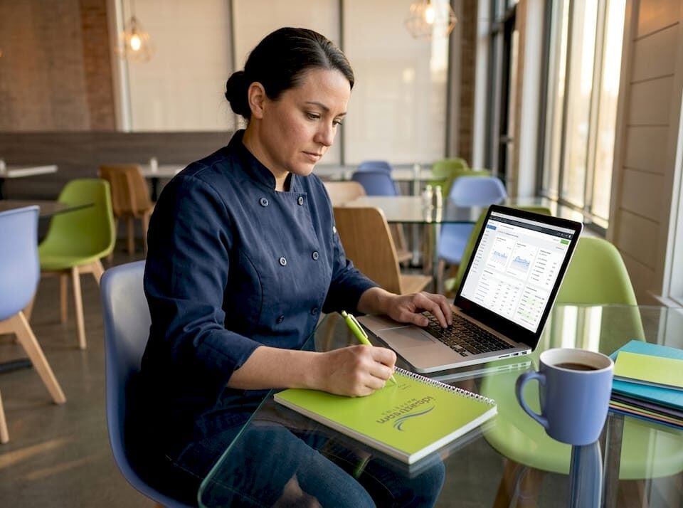Restaurant owner analyzes marketing at table