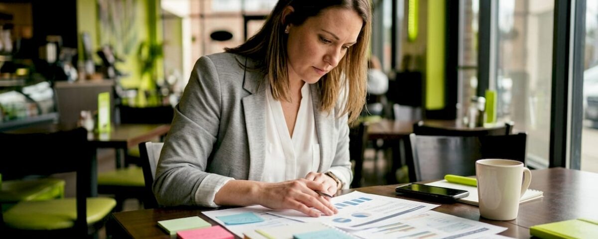 Woman analyzing printed digital marketing documents