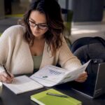 1783765621537_Healthcare-content-strategist-reviewing-report-at-desk | Idea Stream Marketing Healthcare content strategist reviewing report at desk