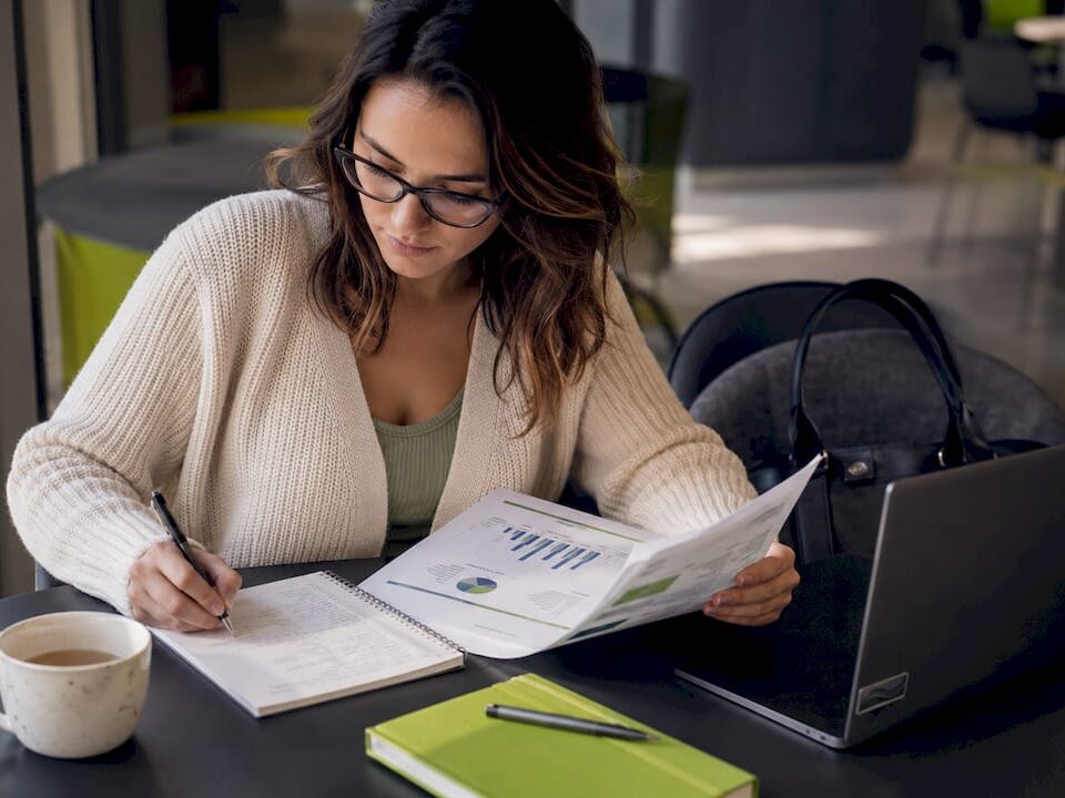 Healthcare content strategist reviewing report at desk