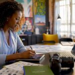 1783966753930_Woman-planning-video-marketing-checklist-at-home-desk | Idea Stream Marketing Woman planning video marketing checklist at home desk