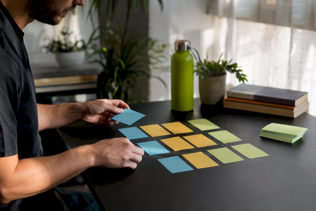 Arranging SEO Keyword Cards | Idea Stream Marketing Hands arranging SEO keyword cards on desk
