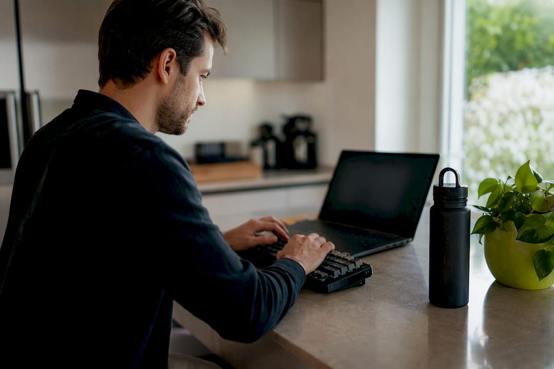 Developer Coding in Kitchen | Idea Stream Marketing Developer typing schema markup code