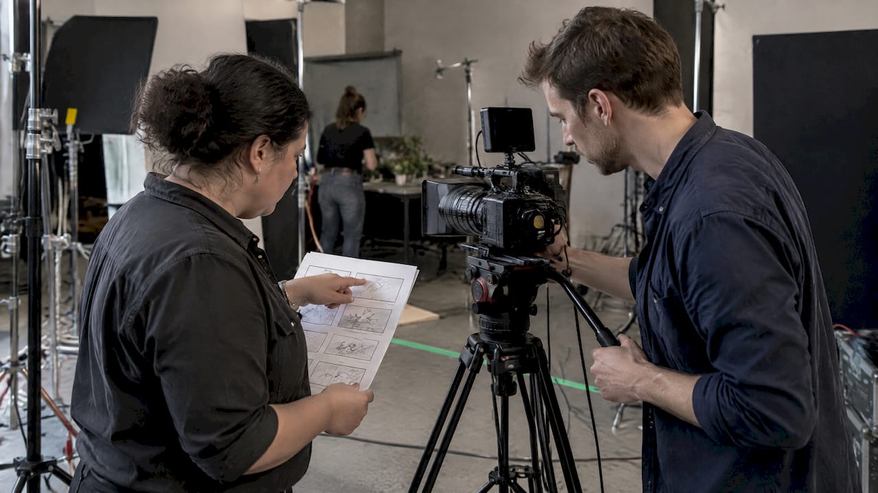 Crew Reviewing Storyboard on Set | Idea Stream Marketing Crew matching storyboard panels to camera setup